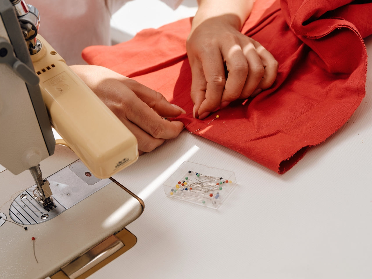 Editorial study of hand-sewing red fabric