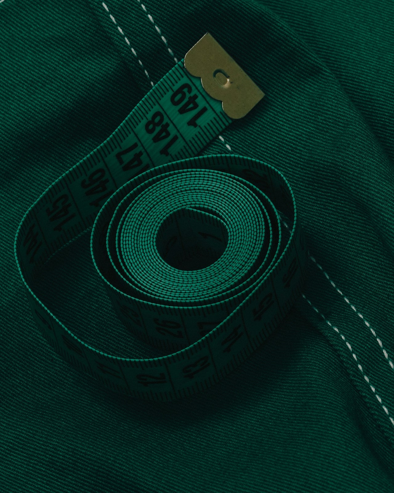 Measuring tape on green fabric